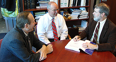 The co-authors sign a copy of their book for Kevin Dillon, Director of Manchester-Boston Regional Airport